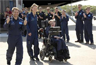 Well-wishers greet physicist Stephen Hawking (in wheelchair) at the Kennedy Space Center Shuttle Landing Facility