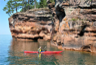 Kayakers enjoy exploring Apostle Islands' sea caves on calm Lake Superior Kayakers enjoy exploring Apostle Islands' sea caves on calm Lake Superior