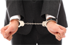 A businessman in handcuffs. Photo by RACOOL from FreeRangeStock.com A businessman in handcuffs. Photo by RACOOL from FreeRangeStock.com
