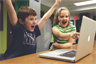 Children playing a computer game Children playing a computer game