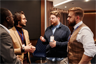 Men in conversation at an event Men in conversation at an event