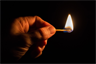 Holding a lighted match Holding a lighted match