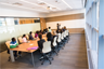 A meeting held in a long conference room. A meeting held in a long conference room.