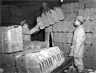 Red Ball Express troops stack "jerry cans" used to transport gasoline to front-line units during World War II. Red Ball Express troops stack "jerry cans" used to transport gasoline to front-line units during World War II.