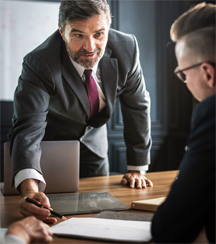 A manager in a posture often associated with bullying A manager in a posture often associated with bullying